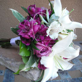 Bouquet of white lilies, purple alstroemeria, and a pink rose