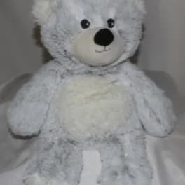 White plush teddy bear with black eyes and nose