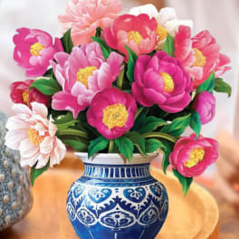 Pink and white peony bouquet in a blue patterned vase