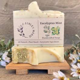 Two bars of eucalyptus mint handcrafted soap stacked on a wooden stand
