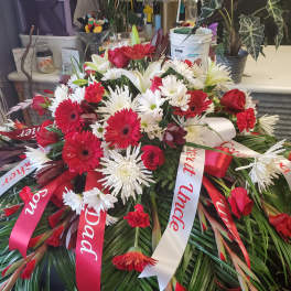 Large red and white funeral spray with ribbons