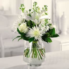White flowers arranged in a clear glass vase