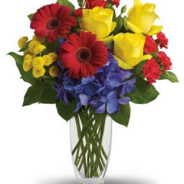 Bouquet of red and yellow flowers in a clear glass vase