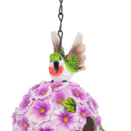 Hanging birdhouse covered in purple flowers with a small bird on top