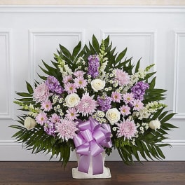 Lavender and white floral spray with a purple ribbon bow