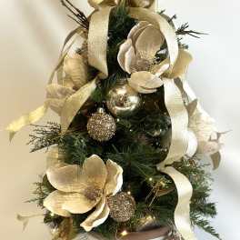 Mini Christmas tree with gold flowers, ribbon, and ornaments in a white pot