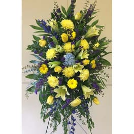 Tall standing floral spray with yellow and purple flowers