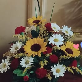 Large bouquet of sunflowers, daisies, and red roses