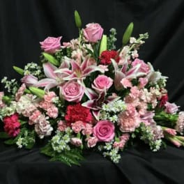Pink roses and lilies arranged in a low bouquet