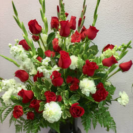 Red roses and white carnations in a black vase