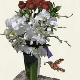 Red roses and white orchids in a tall glass vase