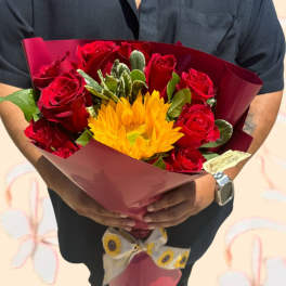 Bouquet of red roses and a yellow sunflower wrapped in burgundy paper