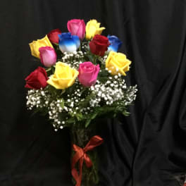 Bouquet of multicolored roses in a glass vase with baby's breath