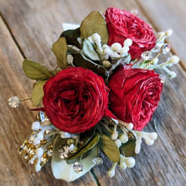 Small bouquet of red roses with white accents and jeweled details