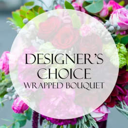 Wrapped bouquet of pink and white flowers with greenery