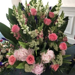 Pink roses and hydrangeas with white snapdragons in a large arrangement