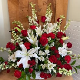 Large basket arrangement of red roses and white lilies