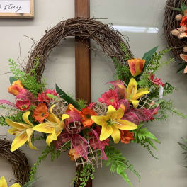 Colorful floral wreath with yellow lilies and orange-pink flowers
