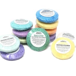 Stacked colorful shower steamers with labeled tops