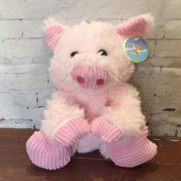 Pink plush pig toy with a tag attached