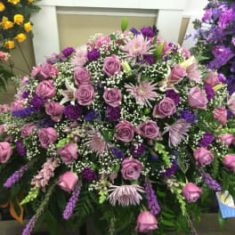 Large purple and pink floral spray with roses and lilies
