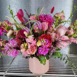 Pink mixed bouquet in a blush vase with calla lilies and dahlias