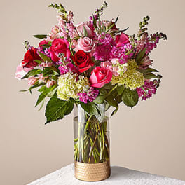 Pink and red rose bouquet in a clear glass vase