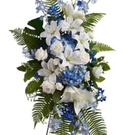 Tall white and blue floral standing spray with lilies and roses