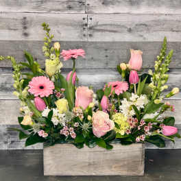 Pink and white mixed flower arrangement in a wooden box