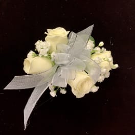 Small bouquet of cream roses with a silver ribbon bow