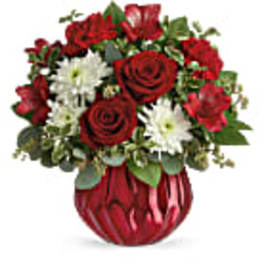Red roses and white daisies in a red vase