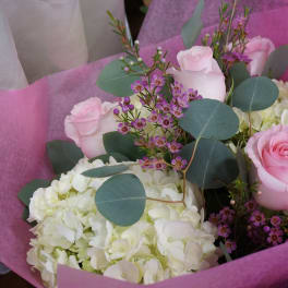 Pink roses and white hydrangeas in pink wrapping