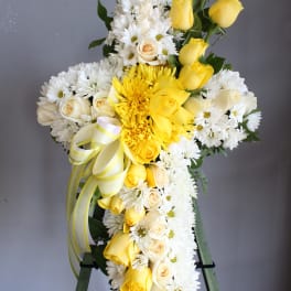 Yellow and white floral standing spray on an easel
