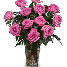Pink roses arranged in a clear glass vase