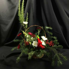Basket arrangement with white and red flowers and evergreen branches