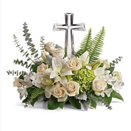 White floral arrangement with a silver cross centerpiece