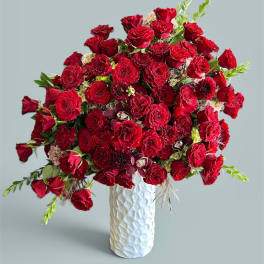 Red rose bouquet in a white textured vase