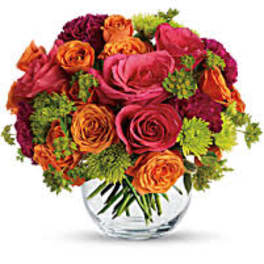Bouquet of orange and pink roses in a clear glass vase