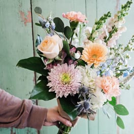 Hand-tied bouquet with peach, pink, and white flowers