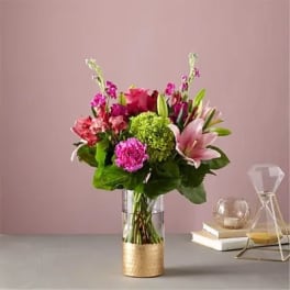 Pink and purple mixed bouquet in a clear glass vase