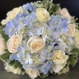 Bouquet of pale blue hydrangeas and cream roses