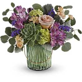 Mixed bouquet with a succulent and roses in a glass vase