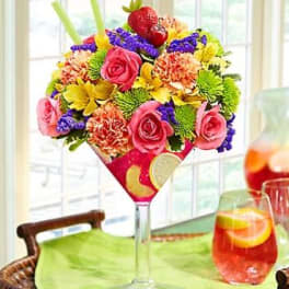 Colorful bouquet in a tall martini glass vase
