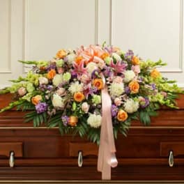 Large floral casket spray with pink lilies and orange roses