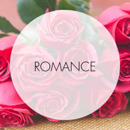 Pink and red roses with the word ROMANCE overlaid in the center