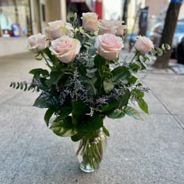Bouquet of pale pink roses in a clear glass vase