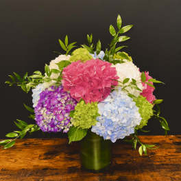 Colorful hydrangea arrangement in a green vase