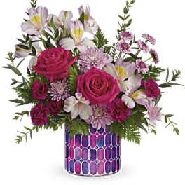 Pink roses and pale lilies in a patterned vase