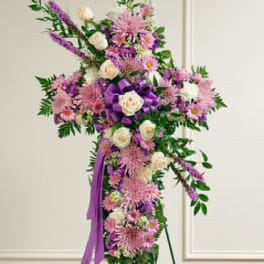 Tall purple and pink floral standing spray with white roses and ribbon