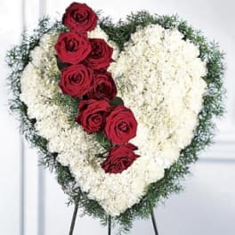 Heart-shaped floral spray with red roses and white flowers